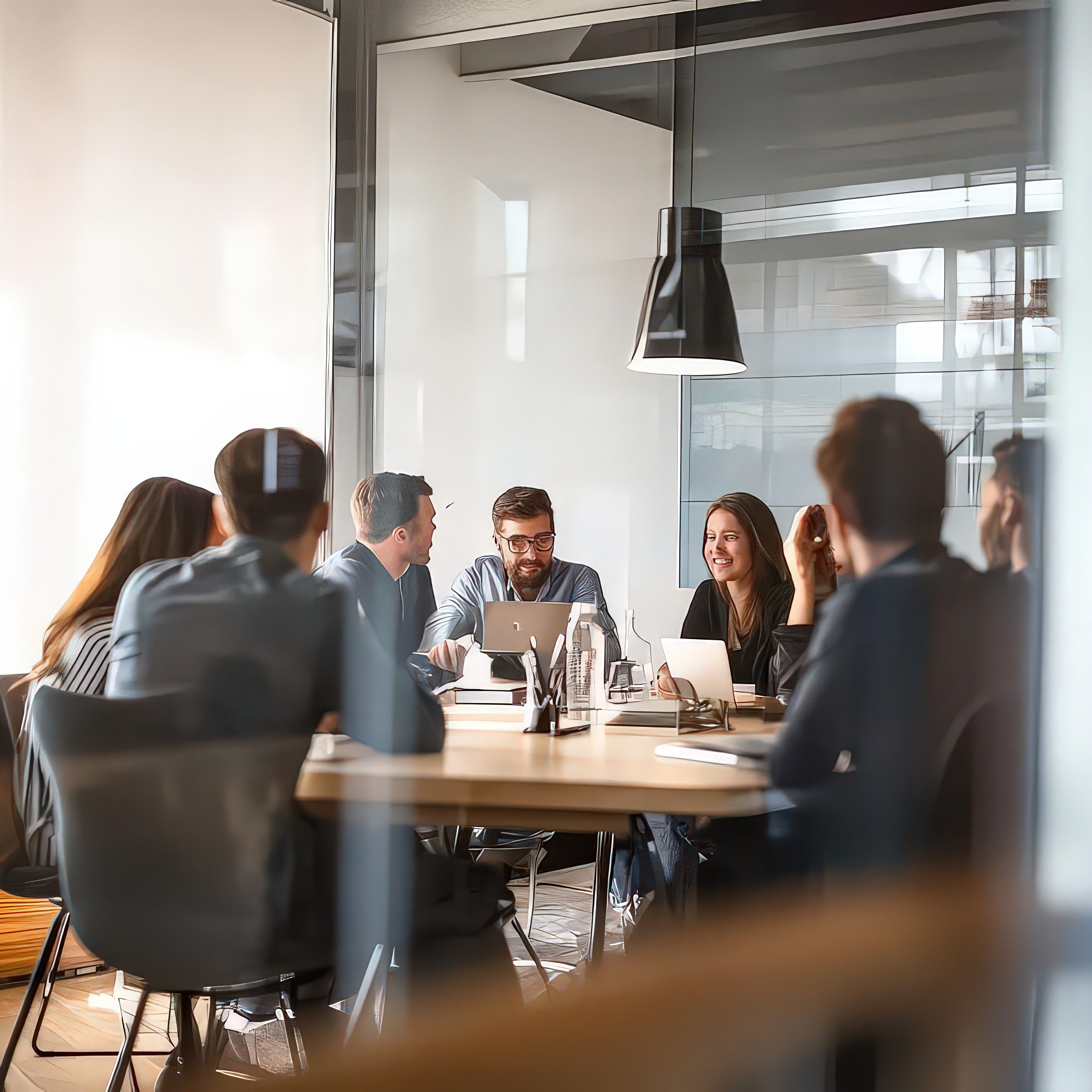 A group of professionals collaborating in a modern meeting room.